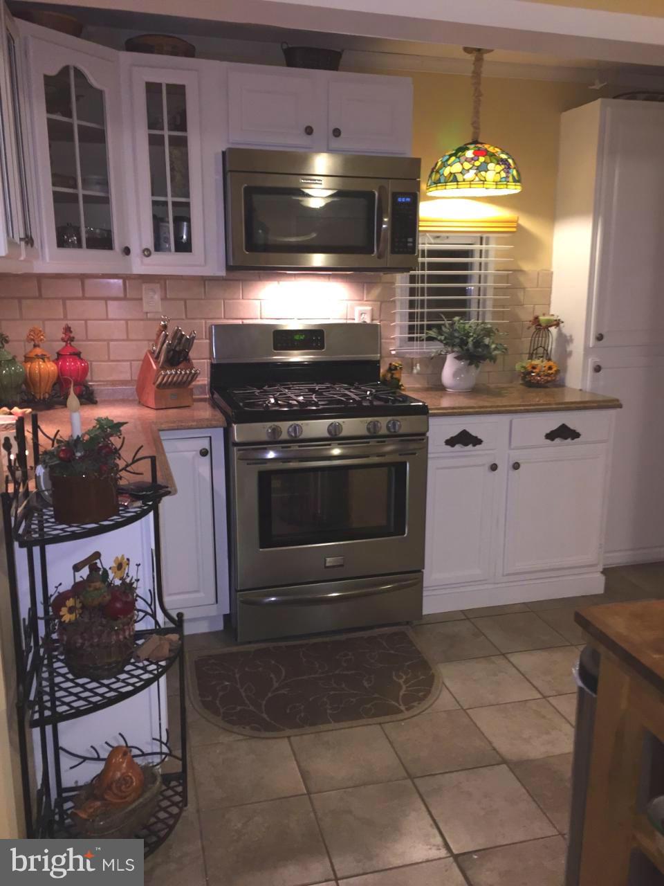229 Baltimore Street Aberdeen, MD 21001 - Photo 4 of 24 a kitchen with a stove and a sink