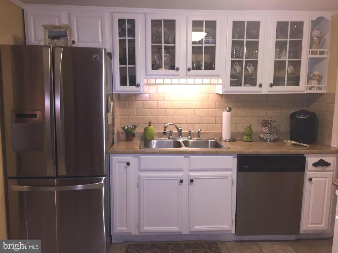 229 Baltimore Street Aberdeen, MD 21001 - Photo 5 of 24 a kitchen with stainless steel appliances granite countertop a refrigerator and a sink