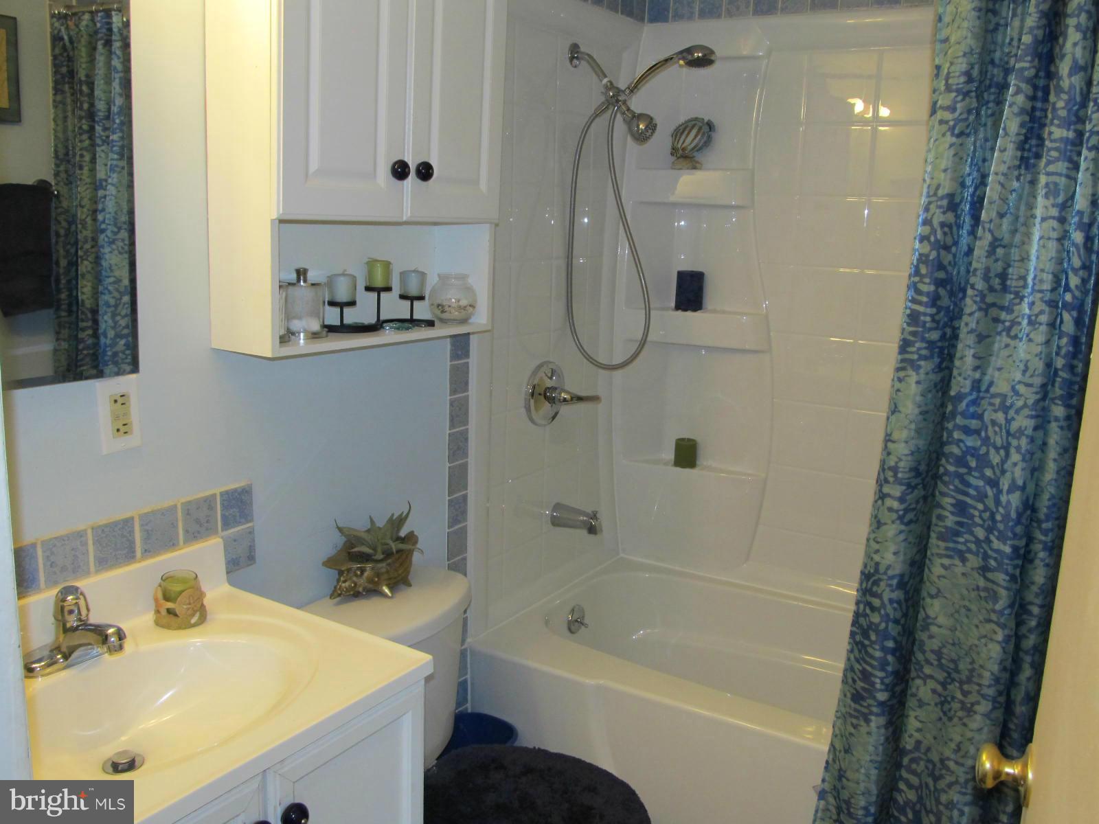 229 Baltimore Street Aberdeen, MD 21001 - Photo 8 of 24 a bathroom with a sink a mirror toilet and bathtub