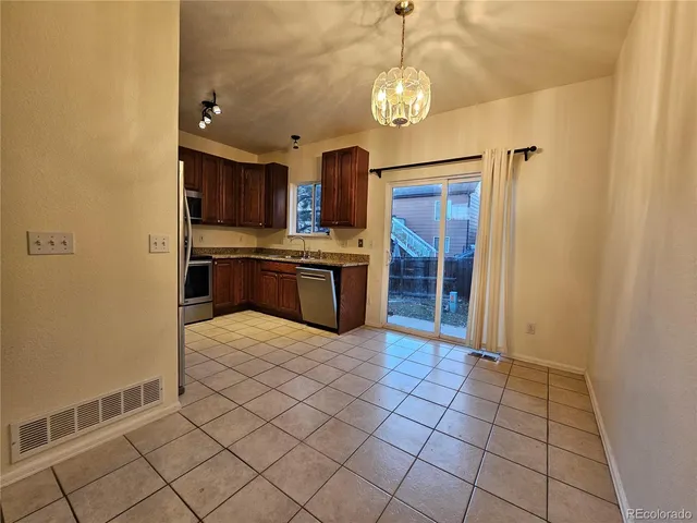 a view of a kitchen with a sink and a refrigerator