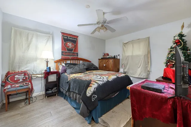 a bedroom with bed and windows