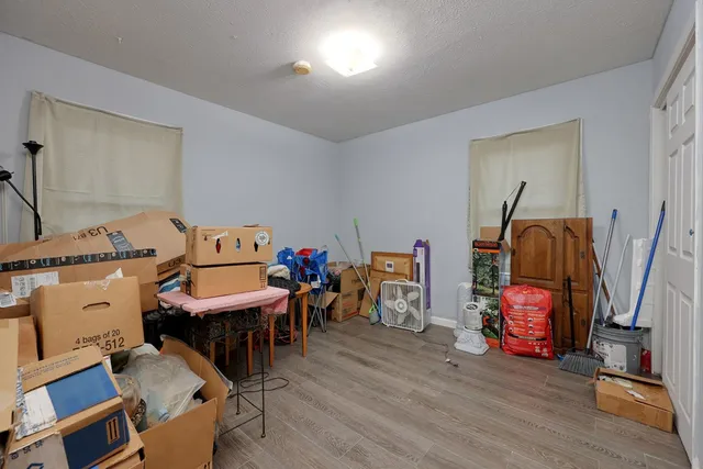 a view of a workspace with furniture and wooden floor
