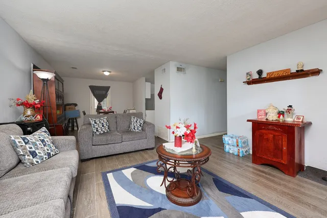 a living room with furniture and a dining table