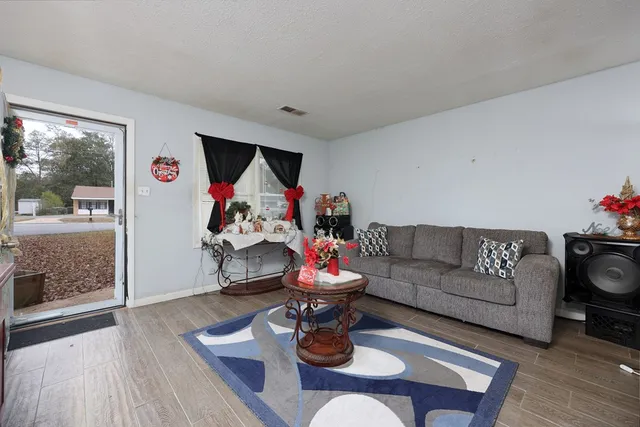 a living room with furniture fireplace and window