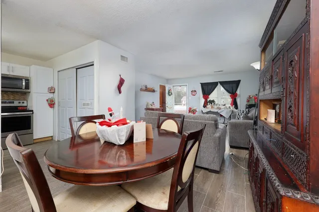 a dining room with furniture and wooden floor