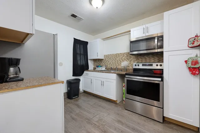a kitchen with a stove and a microwave