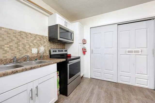 a kitchen with a sink and a stove top oven
