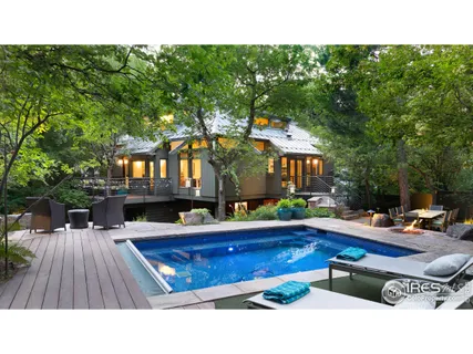 a swimming pool view with a outdoor seating space