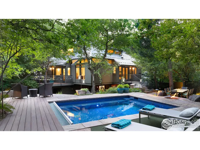 a swimming pool view with a outdoor seating space