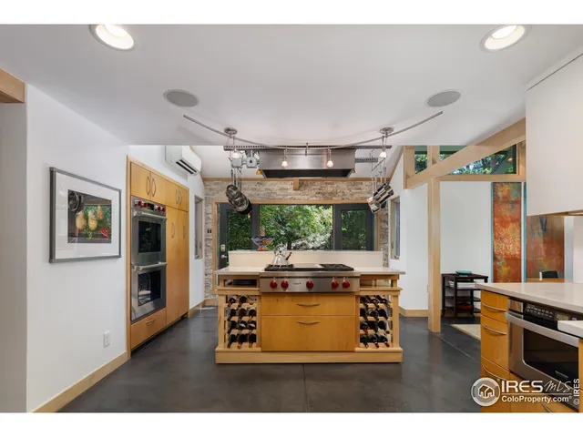 a living room with stainless steel appliances kitchen island granite countertop furniture and a view of kitchen