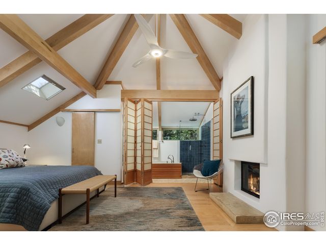 a living room with furniture a large window and gym equipment
