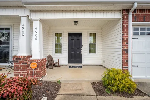a front view of a house with outdoor seating