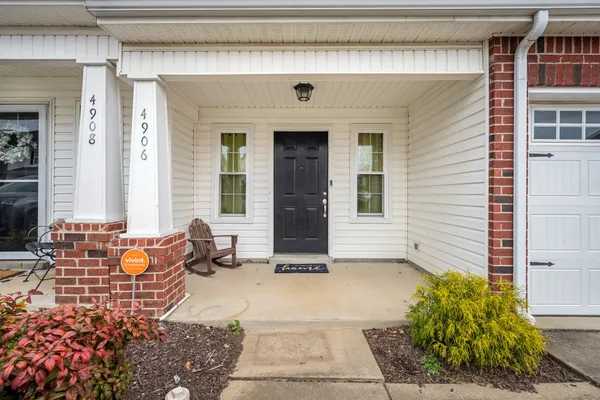 a front view of a house with outdoor seating