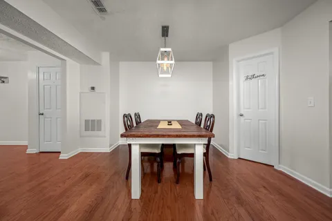 a view of a dining room with furniture wooden floor and a carpet