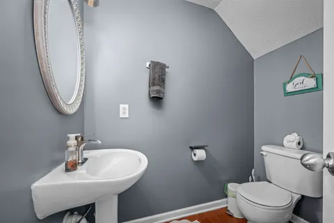 a bathroom with a toilet a sink and a mirror