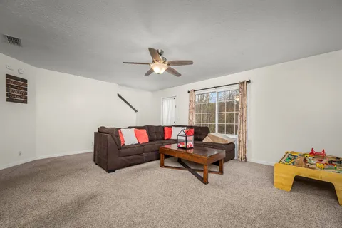 a living room with furniture and a large window