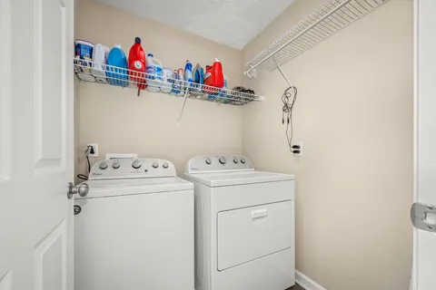 a bathroom with a double vanity sink toilet and shower