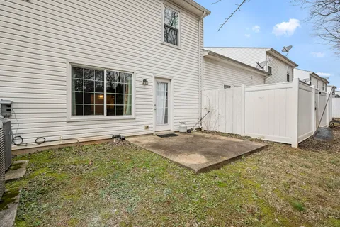 a view of backyard with wooden fence