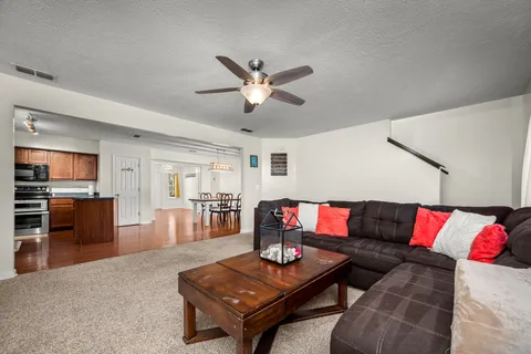 a living room with furniture and wooden floor
