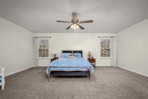 a bedroom with a bed and window