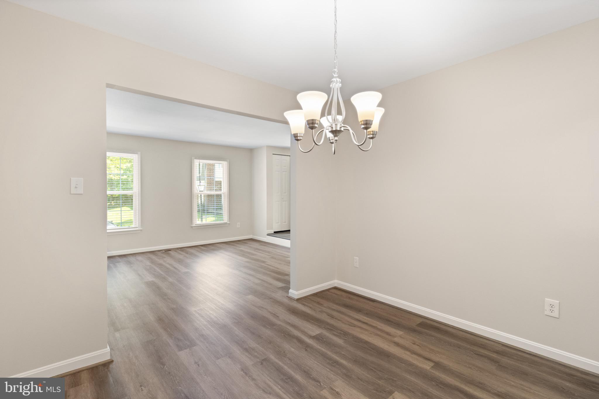 8581 Chester Grove Court Springfield, VA 22153 - Photo 8 of 38 a view of empty room with wooden floor and window