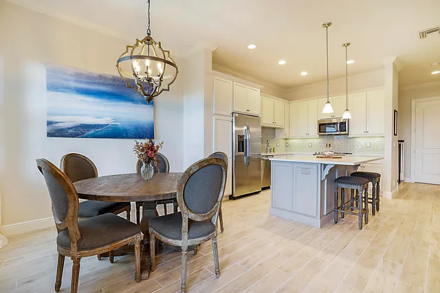 a view of a dining room with furniture wooden floor and chandelier