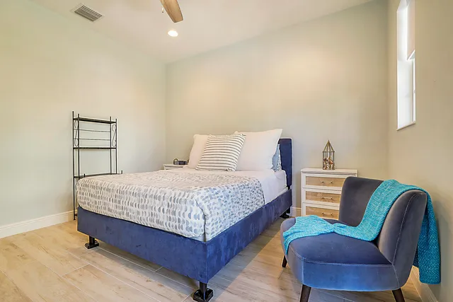 a bedroom with a bed chair and a couch