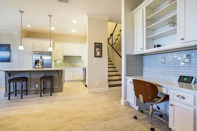 a view of a workspace with furniture and a kitchen