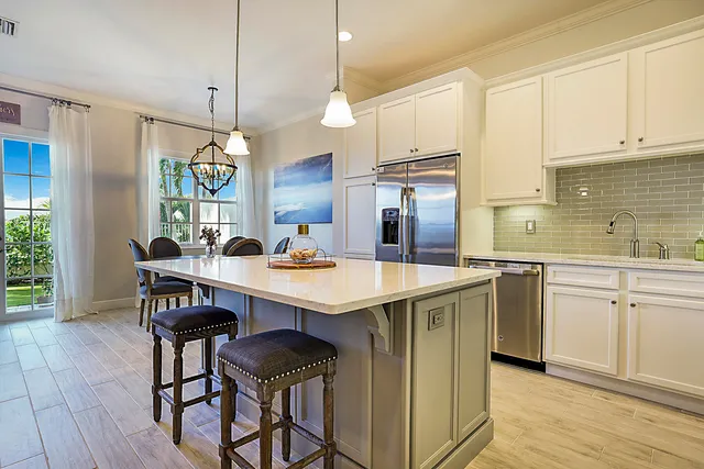 a kitchen with a sink a counter space appliances and cabinets
