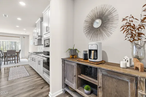 a kitchen with stainless steel appliances a chimney a sink and cabinets