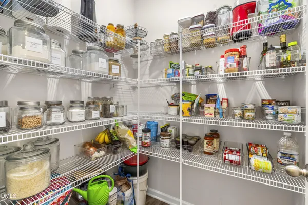 a kitchen with lots of clutter and stainless steel appliances