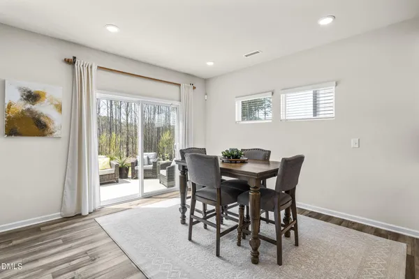 a view of a dining room with furniture and a potted plant