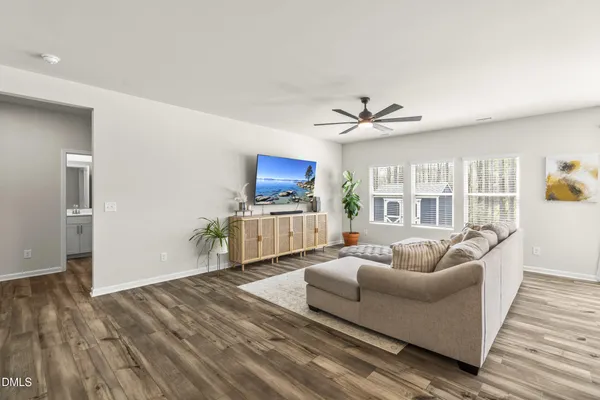 a living room with furniture and a wooden floor