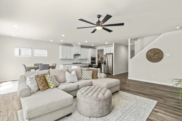 a living room with furniture and a wooden floor