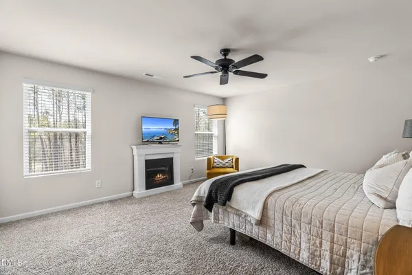 a bedroom with a bed and a fireplace