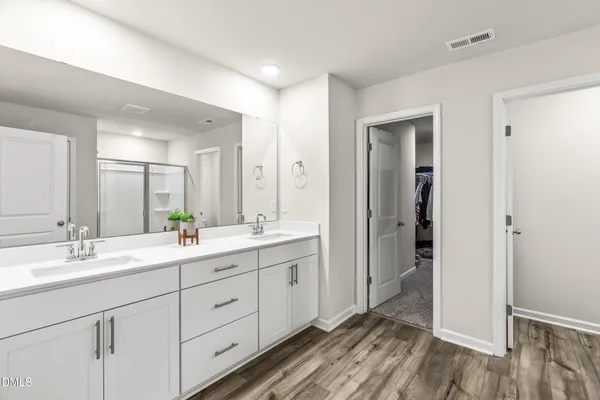a bathroom with a double vanity sink and mirror