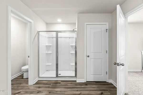 a view of a bathroom with wooden floor and sink