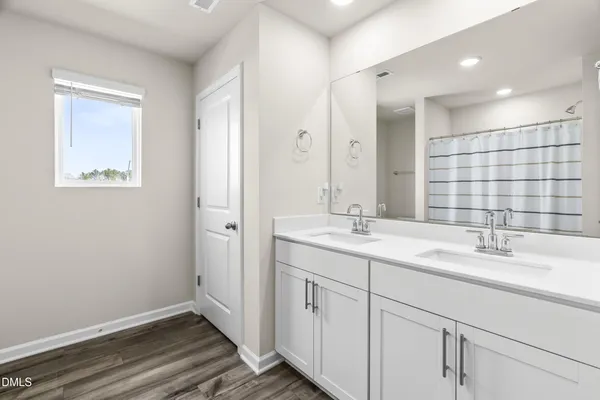 a bathroom with a double vanity sink mirror and double