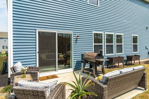a view of a patio with couches chairs and potted plants
