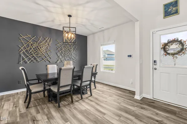 a view of a dining room with furniture window and wooden floor