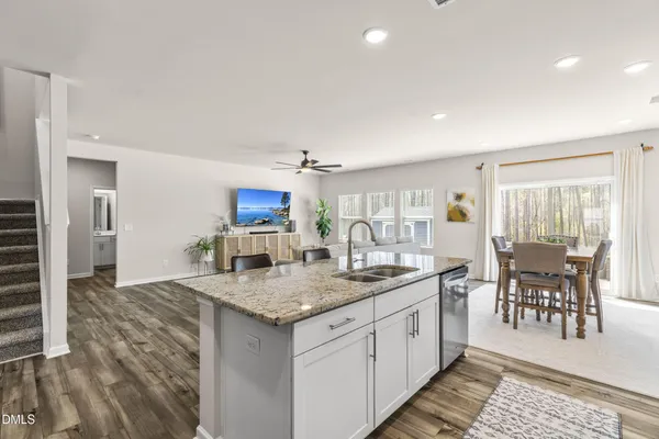 a kitchen with center island table and chairs