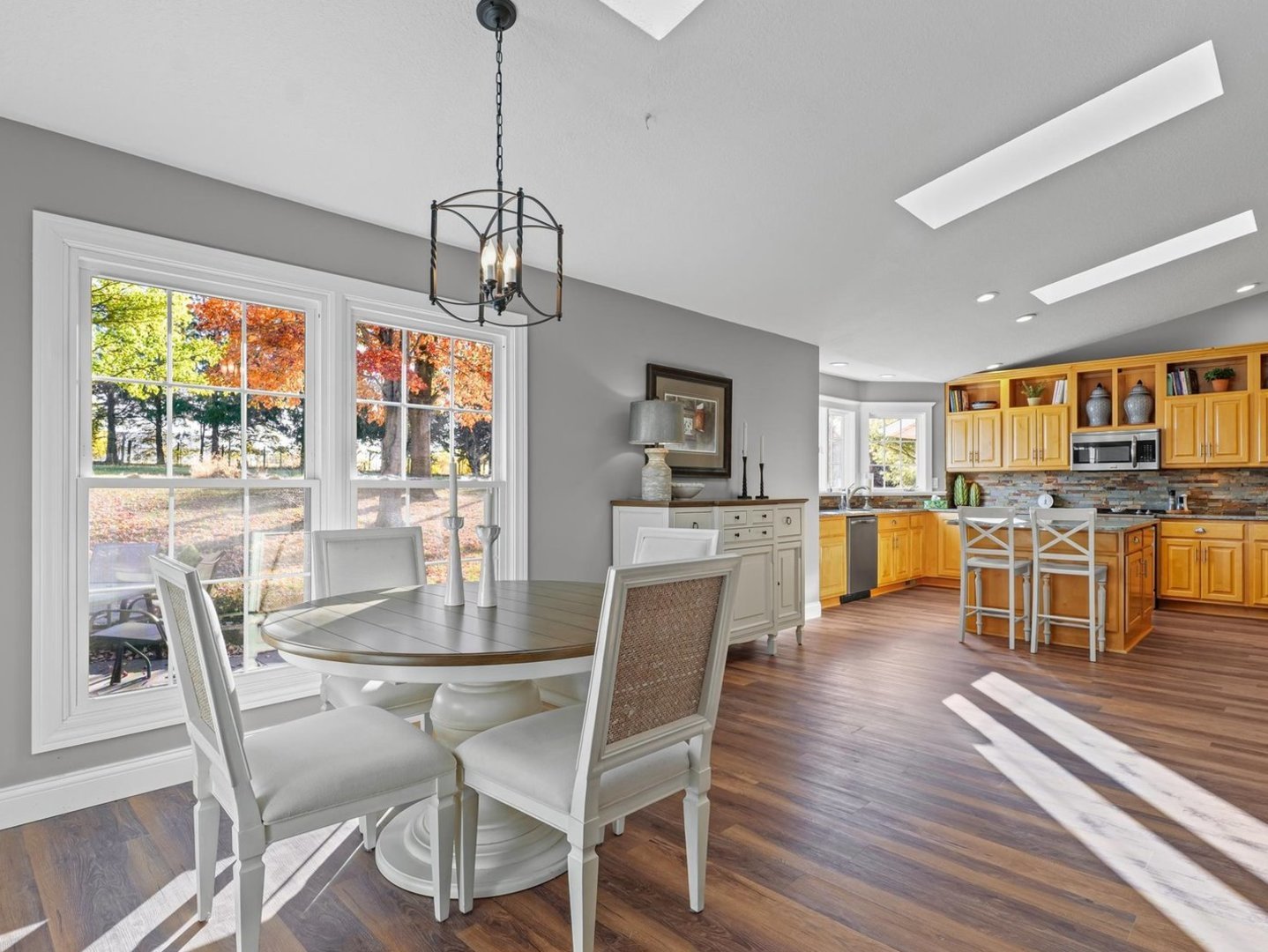 13 Prairie Acres Monticello, IL 61856 - Photo 15 of 53 a view of a dining room and livingroom with furniture wooden floor a chandelier
