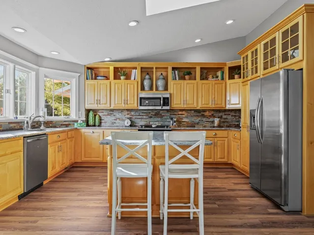 a kitchen with stainless steel appliances granite countertop a stove and a sink
