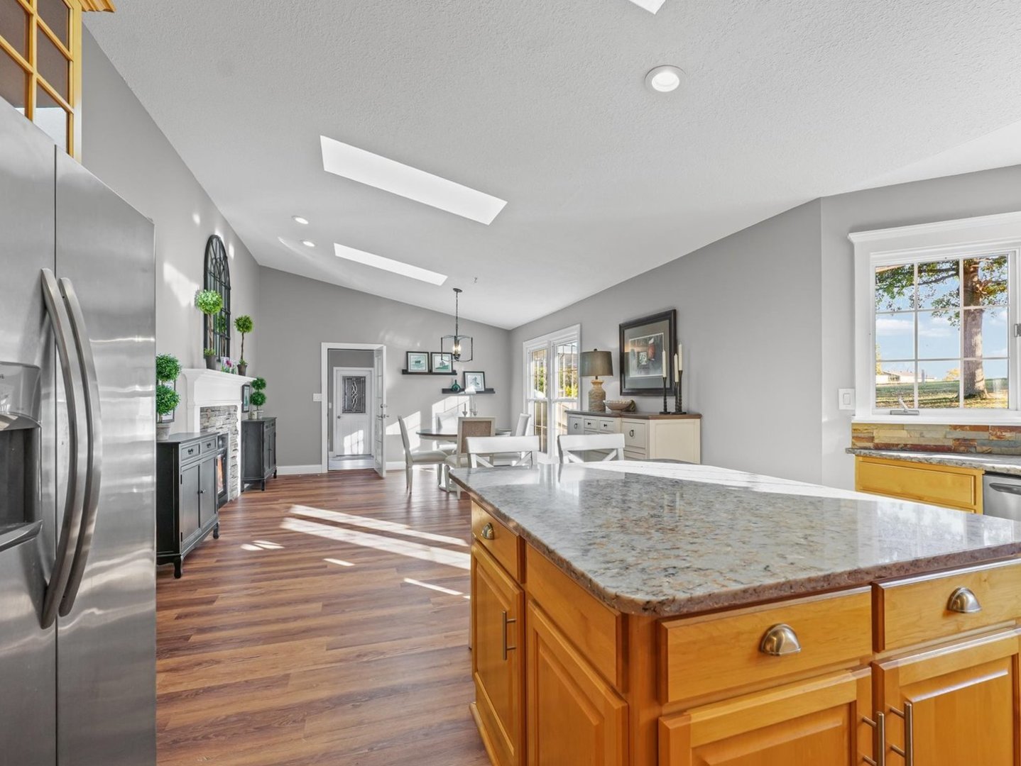 13 Prairie Acres Monticello, IL 61856 - Photo 21 of 53 a kitchen with stainless steel appliances granite countertop a sink counter space and wooden floor