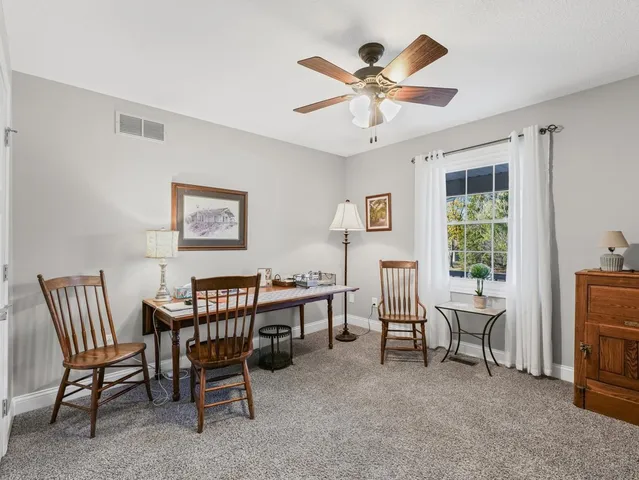 a spacious bathroom with a toilet a sink a mirror and a shower
