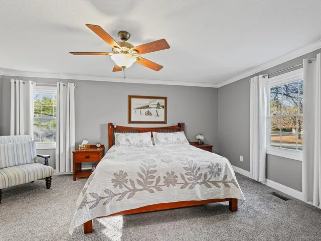 a bedroom with a bed and a couch