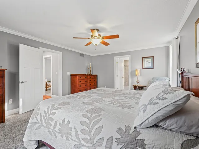 a bathroom with a granite countertop sink a toilet and shower