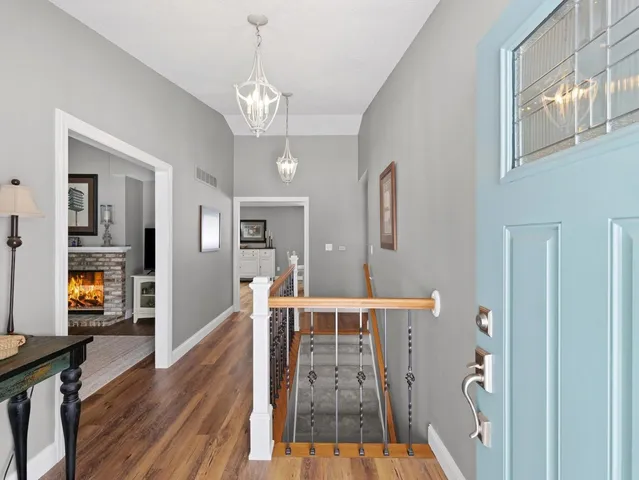 a view of a livingroom with wooden floor and stairs