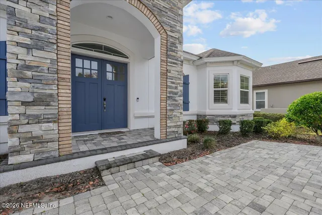 a living room with furniture kitchen view and a flat screen tv