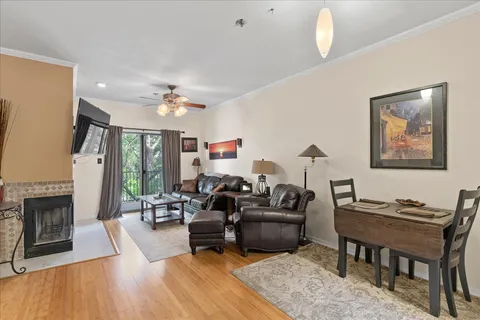 a living room with furniture fireplace and a table